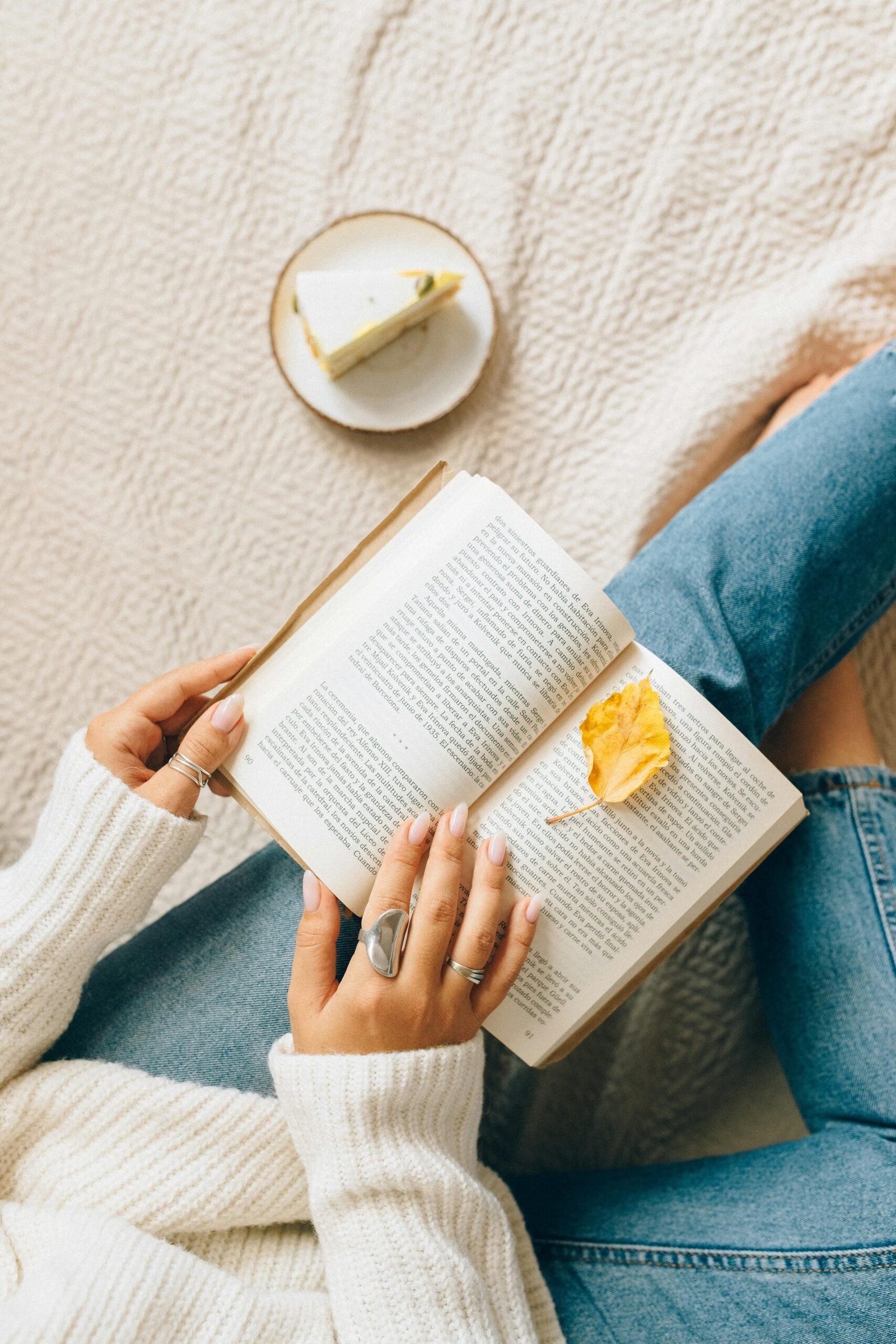 Person enjoying a peaceful moment reading a book in a clean, cozy space.